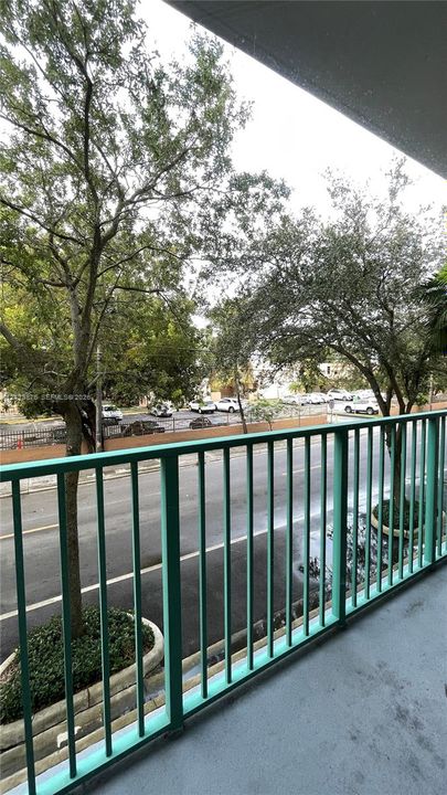 Covered balcony featuring a metal railing and concrete flooring