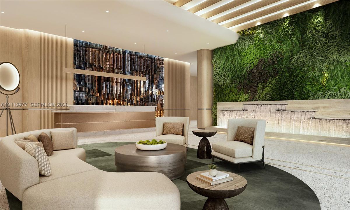 Lobby featuring a built-in stone service desk, textured wood-paneled walls, a multi-tiered stone water feature, and a vertical garden wall with integrated recessed ceiling lighting