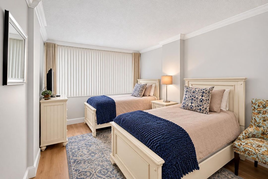 Staged Twin Bedroom with Navy Throws (2)