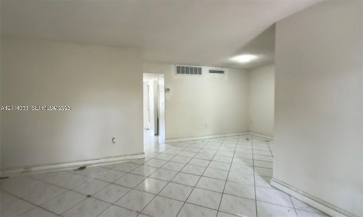 Interior space featuring diagonal-patterned ceramic tile flooring and neutral-toned wall paint
