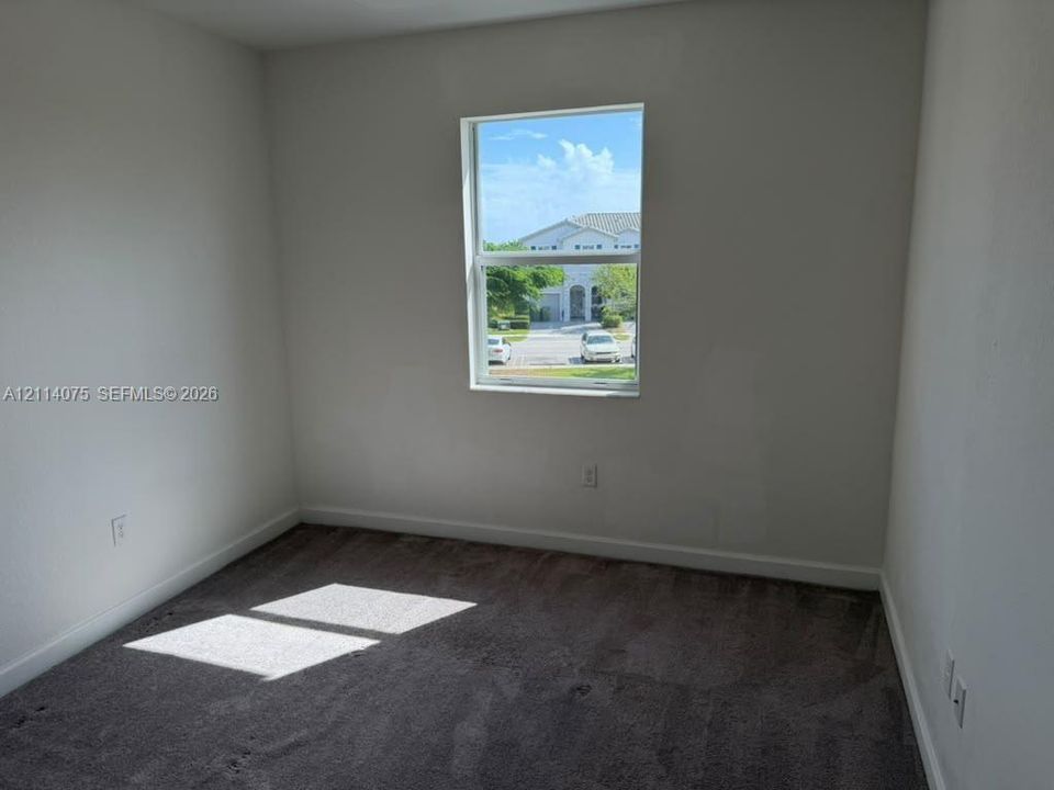 Neutral-toned wall finish, single-hung window, and wall-to-wall carpeting