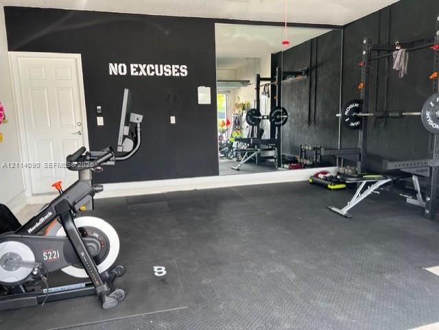 Finished garage space with wall-to-wall mirror and protective rubber flooring
