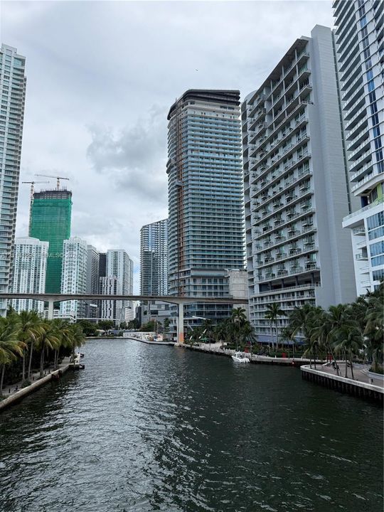 Waterfront location featuring concrete bulkhead seawalls, palm tree landscaping, and direct access to an urban waterway