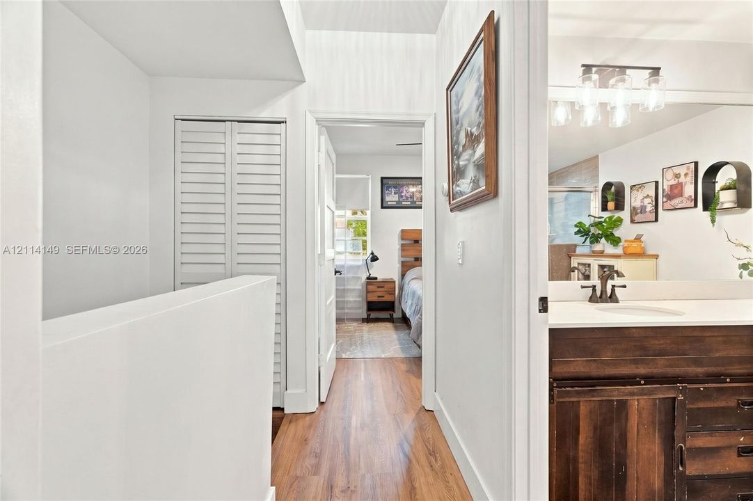 Bathroom featuring a vanity with dark-finish wood cabinetry, a solid surface countertop with an integrated sink, and an overhead multi-light fixture