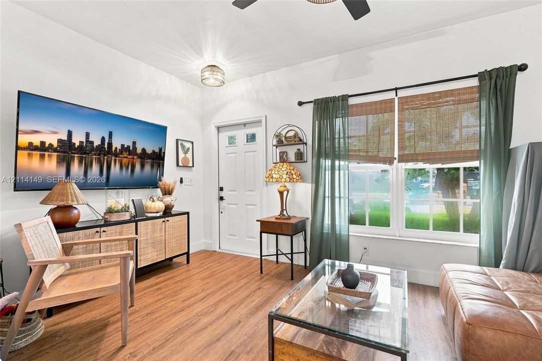 Wood-finish flooring, white walls, dual-pane windows, and a flush-mount light fixture