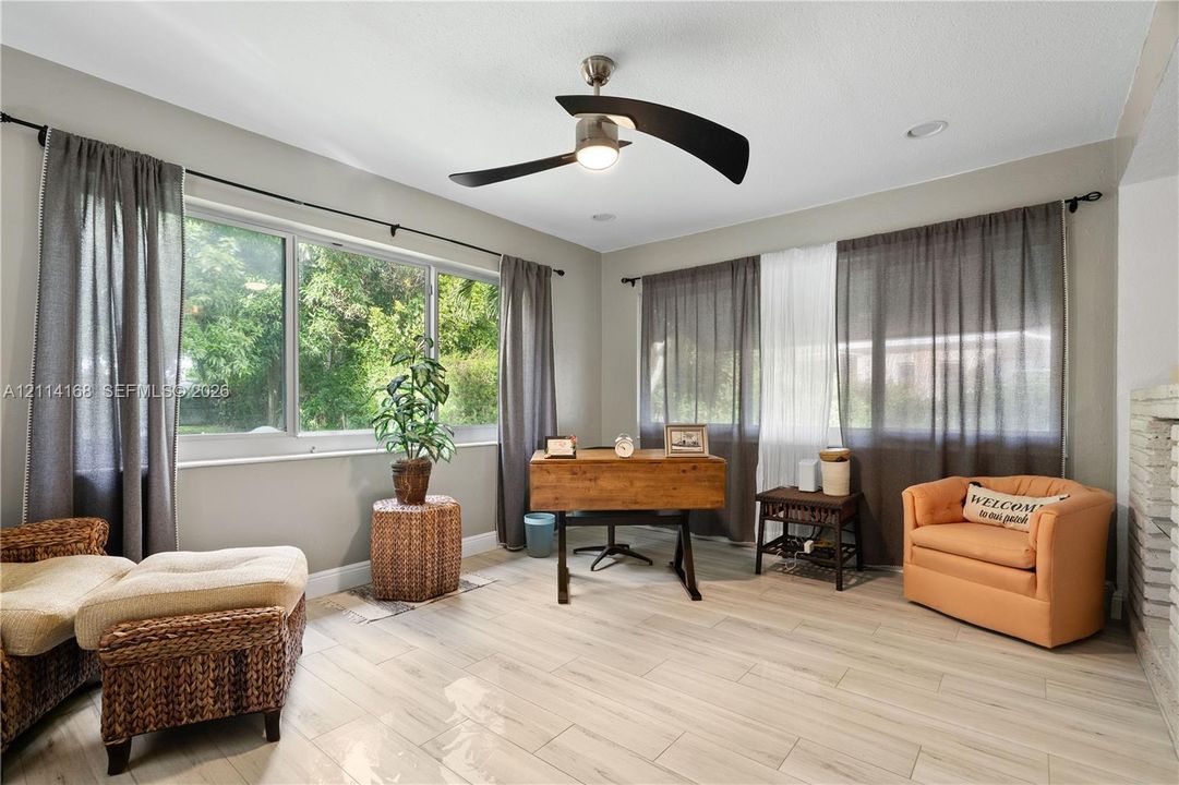 Dual-aspect windows, modern three-blade ceiling fan with integrated lighting