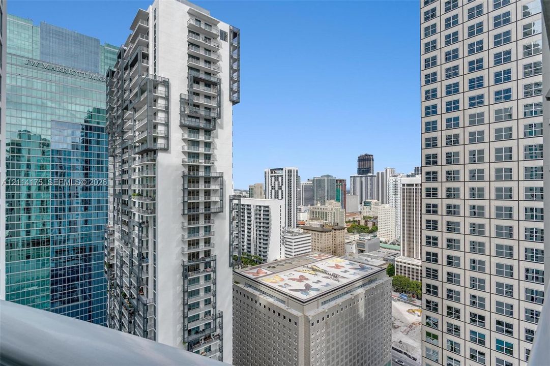 High-rise balcony railing featuring metal construction and expansive urban skyline scenery