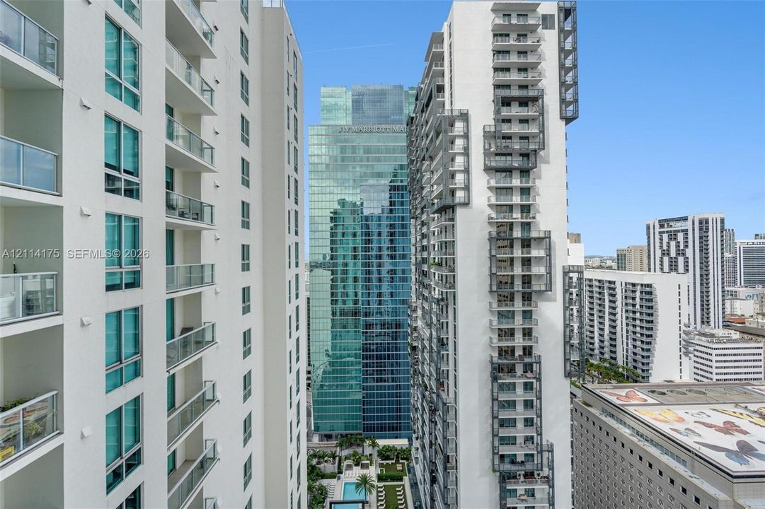 High-rise architecture featuring glass-railed balconies and floor-to-ceiling windows