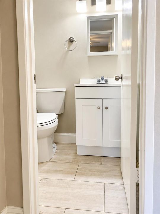 9. Half Bathroom with Vanity and Mirror