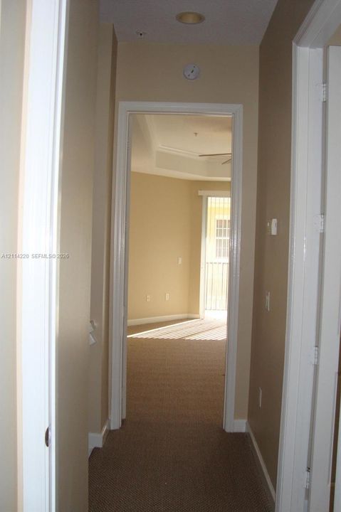 Hallway featuring neutral wall tones, inset ceiling lighting, and carpeted flooring
