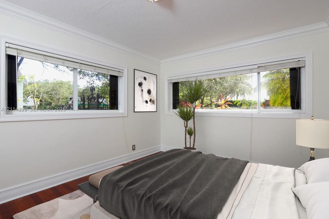 Horizontal windows with white trim, crown molding, and wood-finish flooring