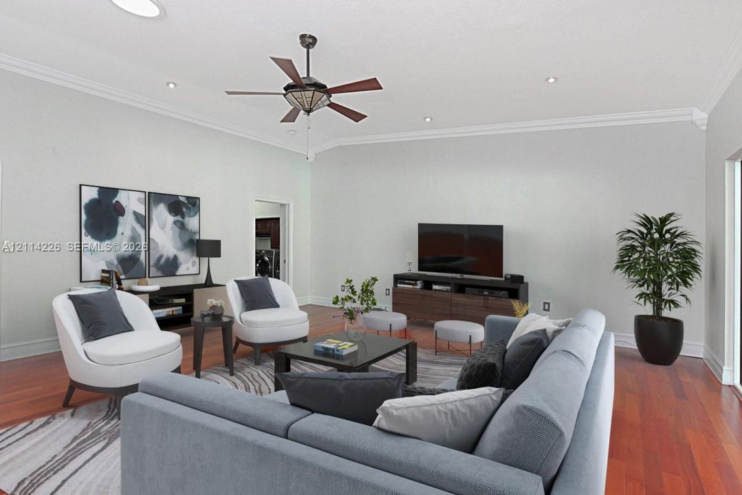 High ceilings featuring crown molding, recessed lighting, a ceiling fan, and wood-finish flooring