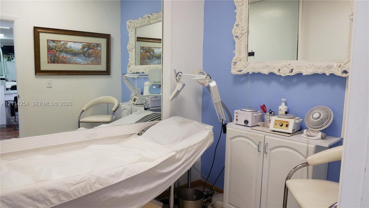 Full-height wall mirror and white built-in storage cabinet with cabinet-style doors