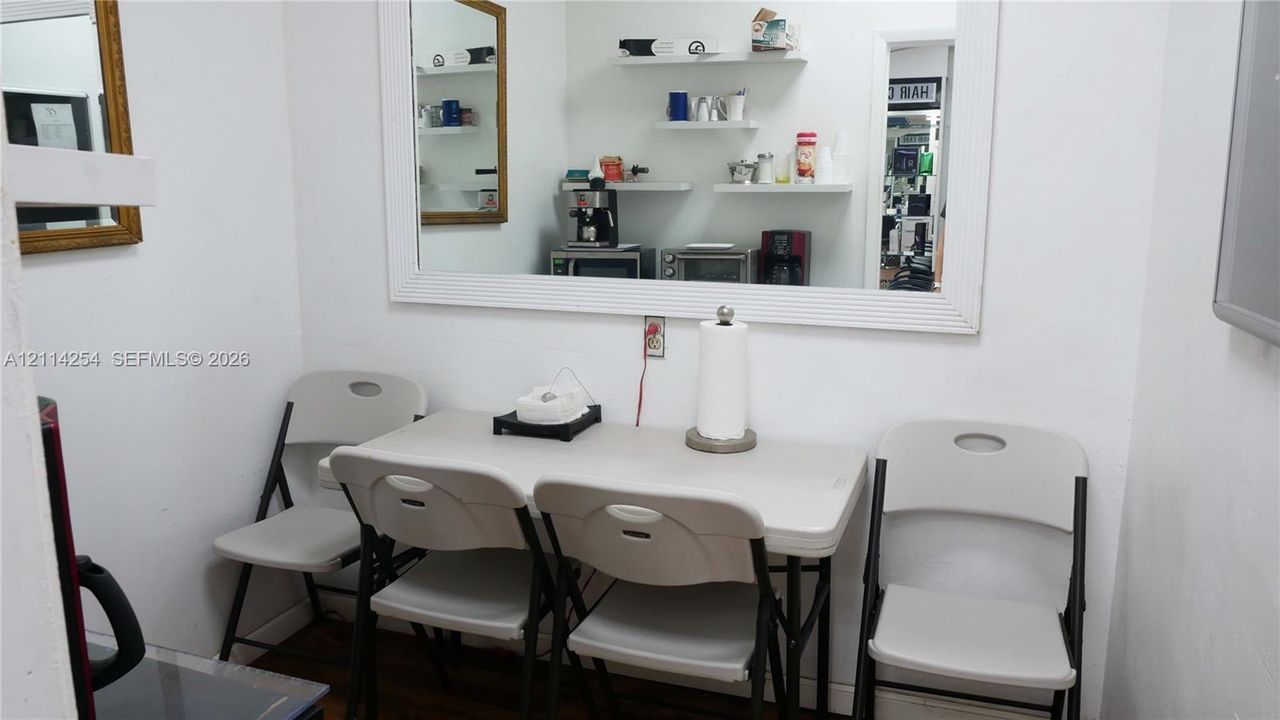 Large wall-mounted mirror with a wide white frame and tiered floating wall shelving