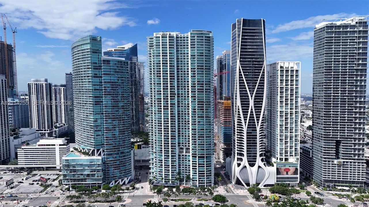 High-density metropolitan skyline featuring glass-curtain wall skyscrapers, reinforced concrete structural facades, and multi-story high-rise architecture