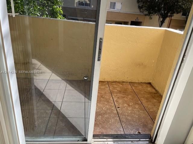Private balcony featuring tile flooring and stucco perimeter walls