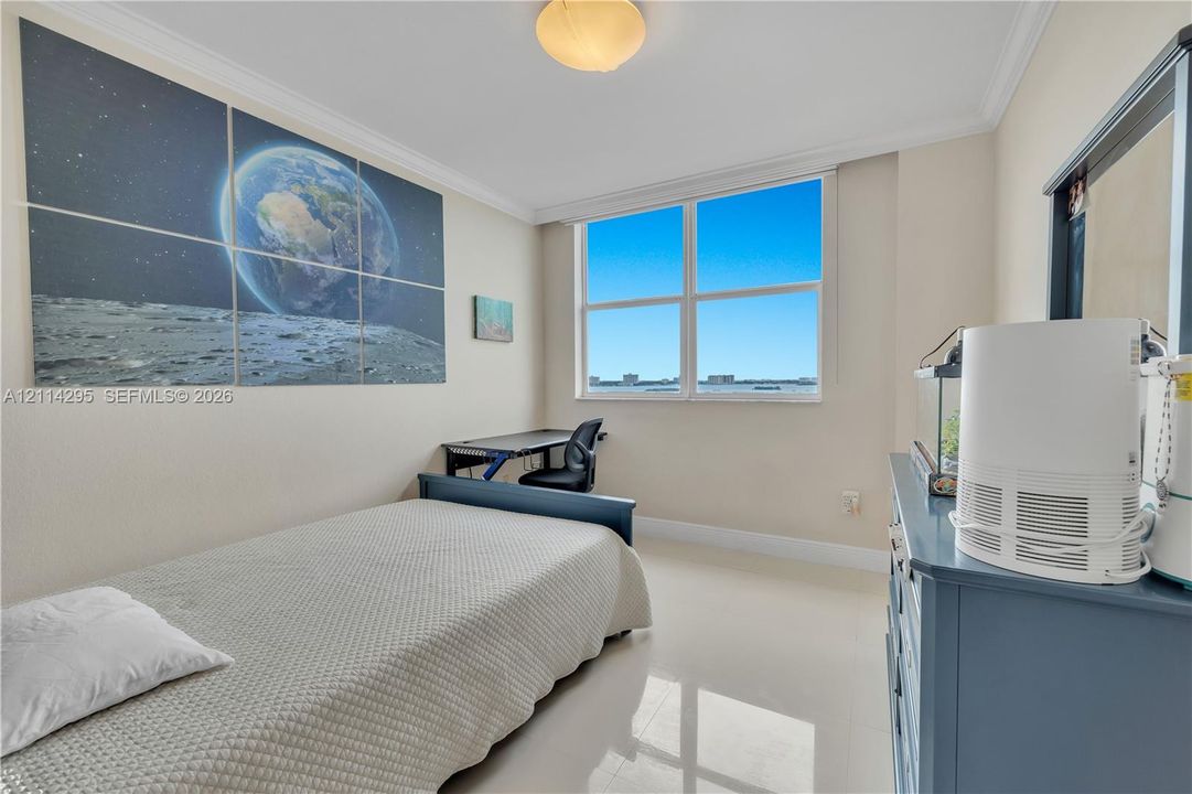 Interior room featuring large windows, crown molding, and light-toned flooring