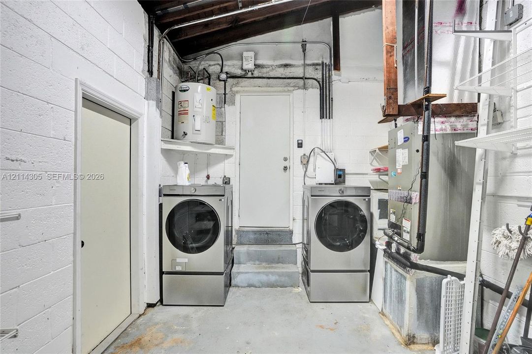 Utility area featuring a water heater, central HVAC unit, concrete walls, and concrete flooring