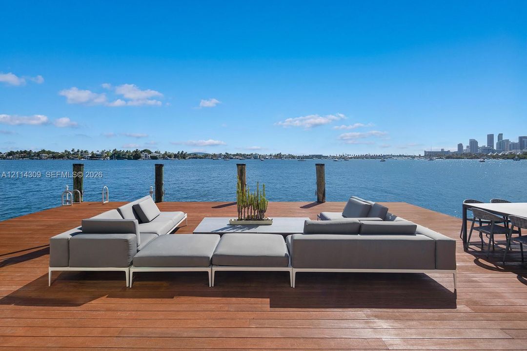 Waterfront wooden deck featuring built-in pilings and open water exposure