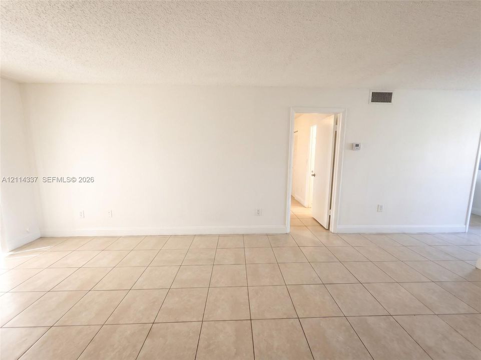 Interior space featuring neutral wall tones and large-format ceramic tile flooring