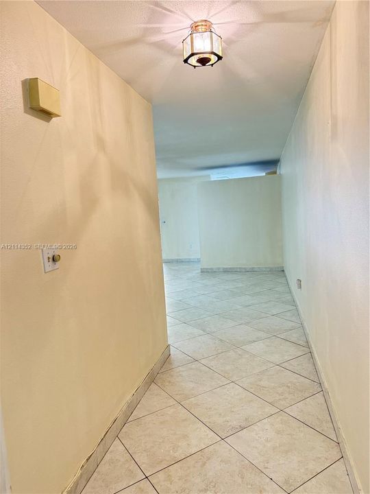 Neutral-toned interior featuring diagonal tile flooring and an octagonal flush-mount ceiling light fixture