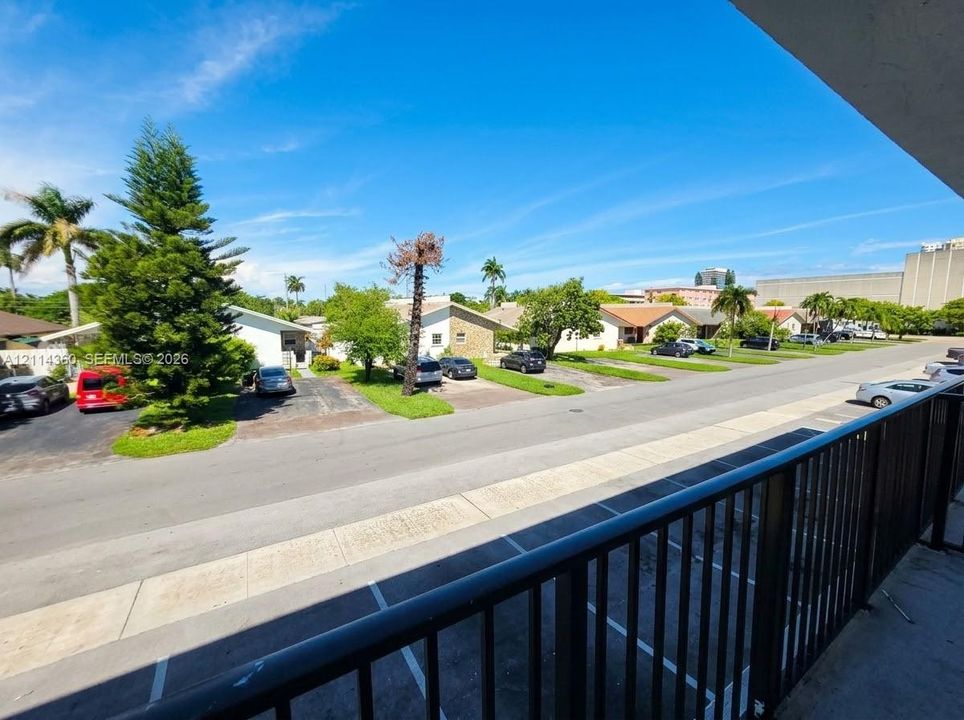 Elevated balcony featuring black metal railings and overhead soffit