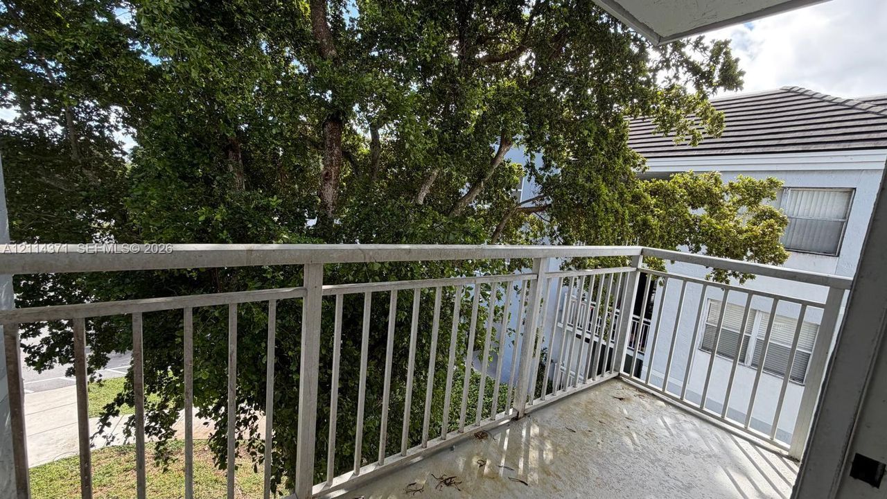 Private balcony featuring metal railings and concrete flooring