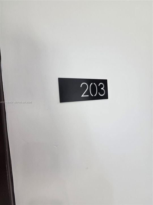 Minimalist black rectangular signage featuring high-contrast white numerals