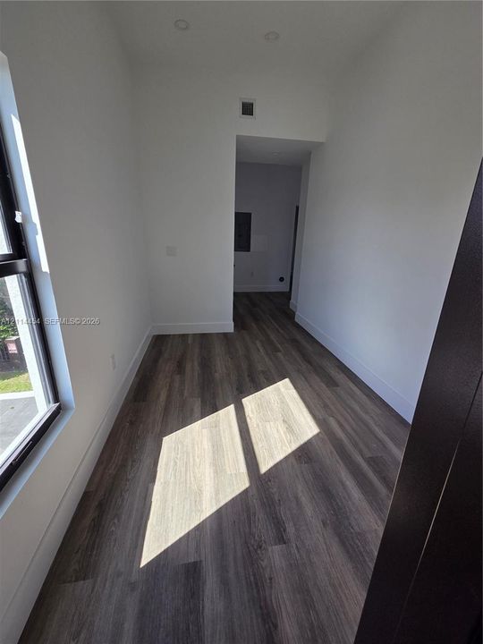 Interior room featuring wood-finish flooring, recessed lighting, and a large window