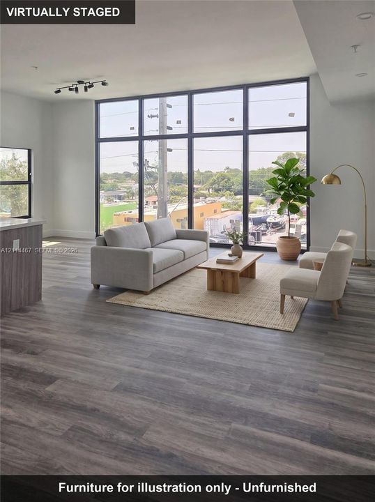 Floor-to-ceiling windows with black frames, wood-finish flooring, and multi-directional track lighting