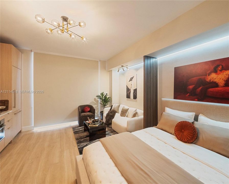 Contemporary interior featuring light wood-finish flooring, multi-light sputnik chandelier, recessed architectural lighting, and built-in vertical cabinetry