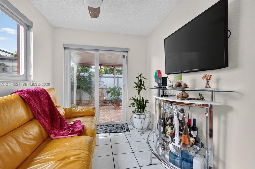 Ceramic tile flooring, sliding glass door, and wall-mounted television bracket