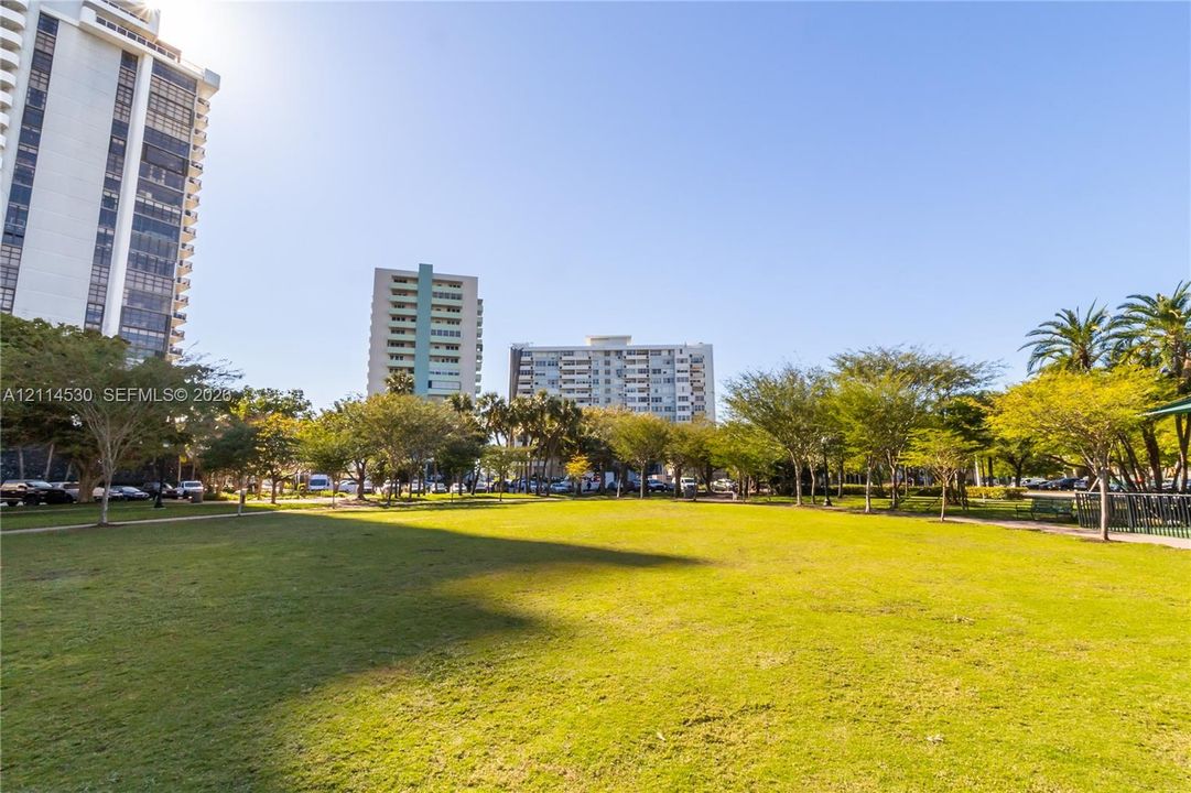 Expansive grass lawn featuring mature trees and established landscaping