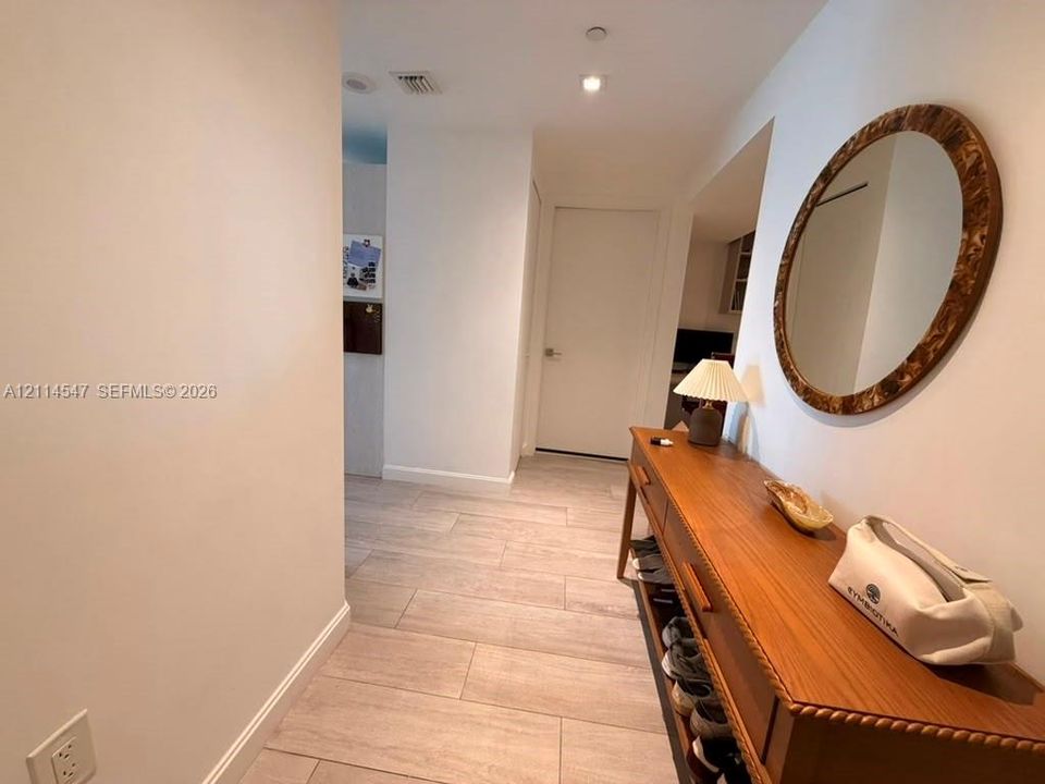 Entryway featuring large-format ceramic tile flooring and neutral wall finishes