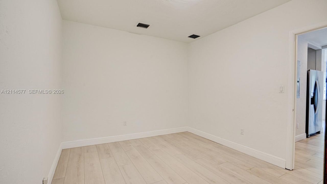 Interior space featuring wood-finish tile flooring and neutral wall paint