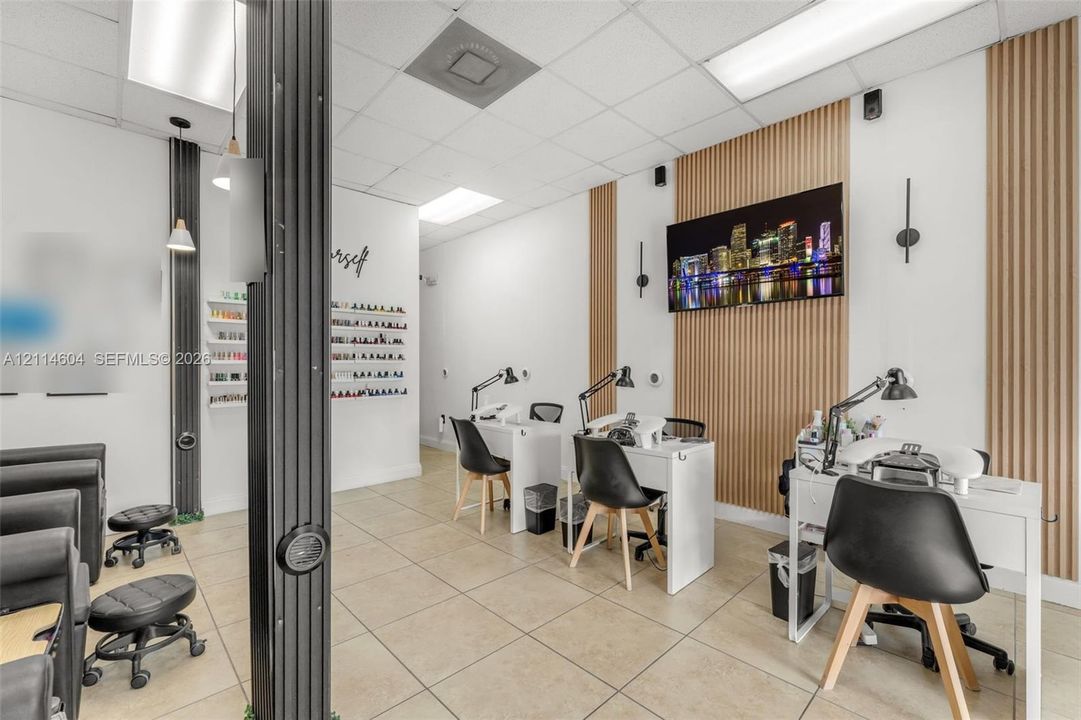 Interior space featuring light tile flooring, vertical wood-slat accent wall paneling, built-in shelving, and recessed ceiling lighting