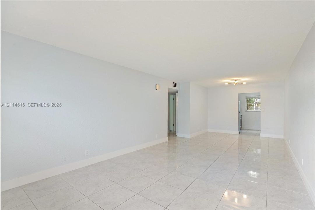 Neutral-toned interior featuring large-format tile flooring and a ceiling-mounted light fixture