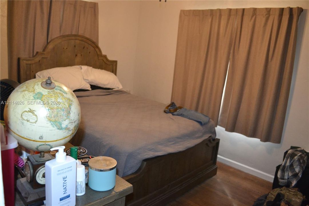 Neutral-toned interior walls featuring wood-finish flooring