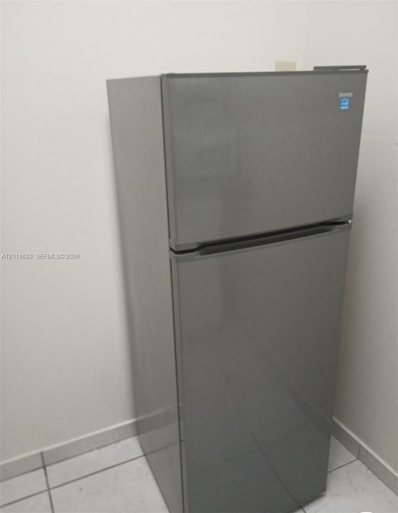 Top-mount refrigerator featuring a stainless-steel finish and Energy Star certification