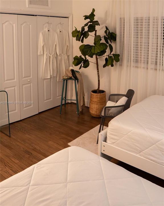 Wood-finish flooring, multi-panel closet doors, and window treatments