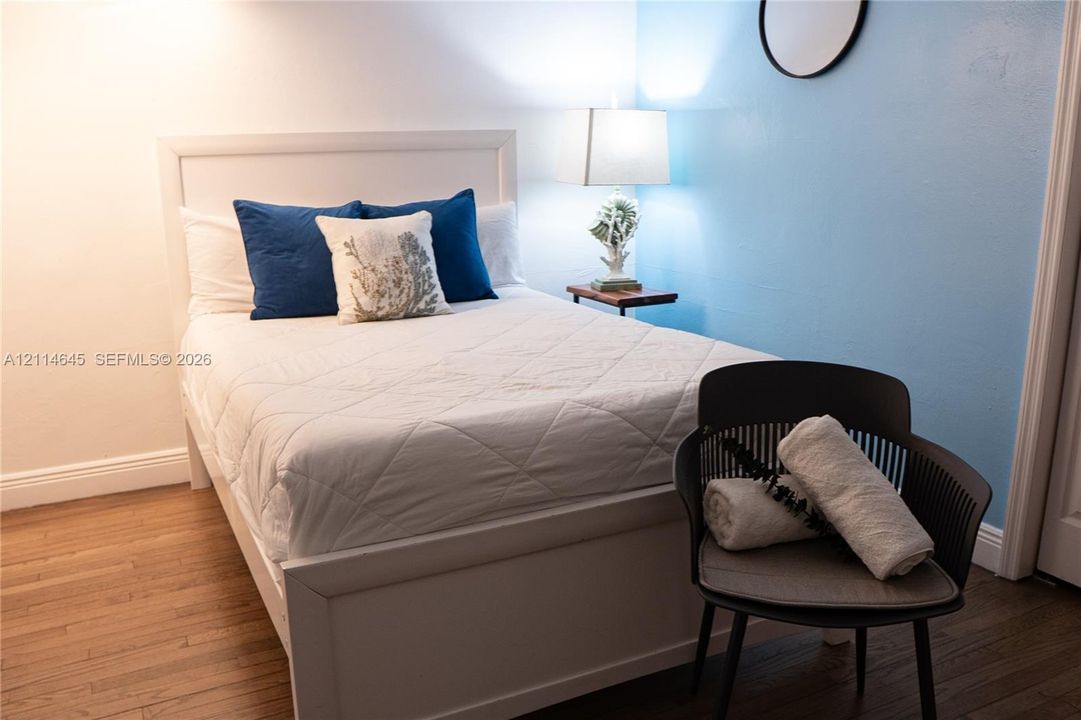 Wood-finish flooring and accent wall painted in soft blue