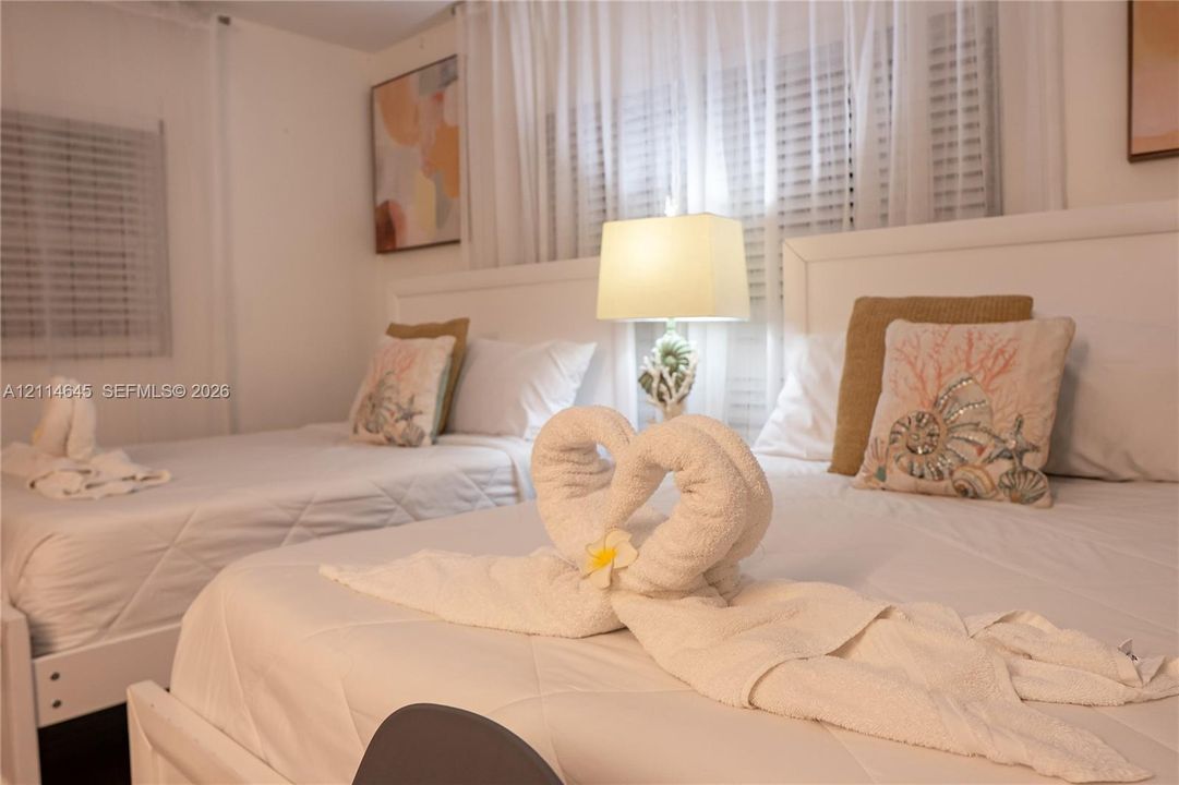 Room featuring horizontal window blinds and sheer window treatments