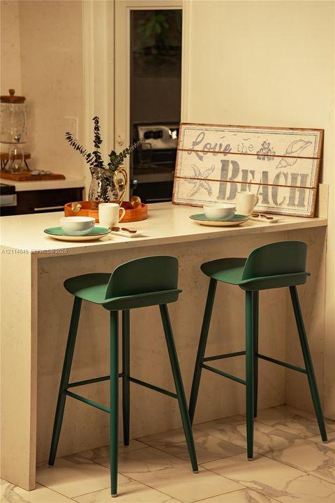 Countertop with waterfall edge, integrated flat-surface finish, and tile flooring