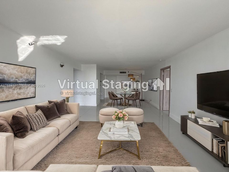 Open-concept interior featuring smooth-finish ceiling, polished neutral tile flooring, and integrated wall-mounted lighting