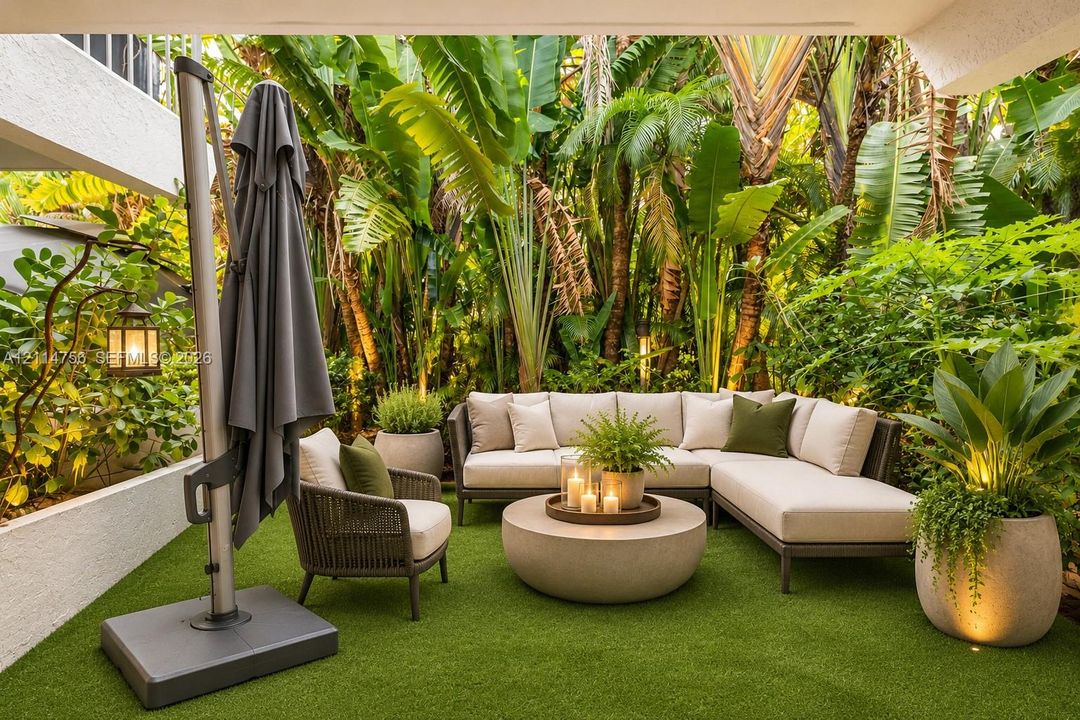 Covered patio featuring synthetic turf, structured retaining walls, and mature tropical landscaping