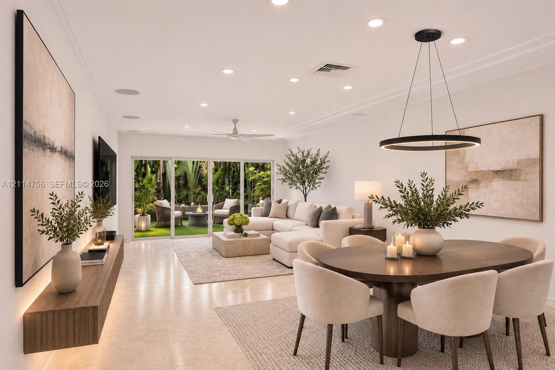 Open-concept living space featuring large-format tile flooring, recessed lighting, a modern circular LED pendant fixture, and a floating wood-finish media console with integrated under-cabinet lighting