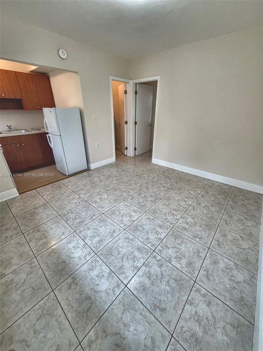 Ceramic tile flooring, wood-finish cabinetry, and neutral wall tones