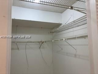 Storage closet featuring white interior walls and multi-level ventilated wire shelving