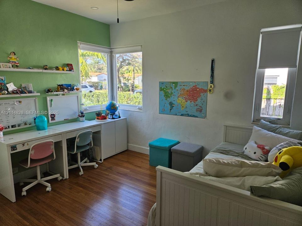 Wood-finish flooring, corner windows, built-in shelving, and recessed lighting