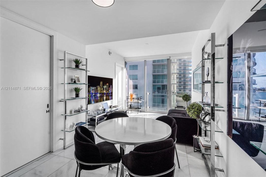 Floor-to-ceiling glass windows, polished tile flooring, and integrated metal shelving units